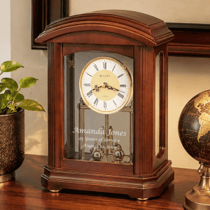 Elegant wooden mantel clock with glass case and gold accents, perfect for classic home decor.